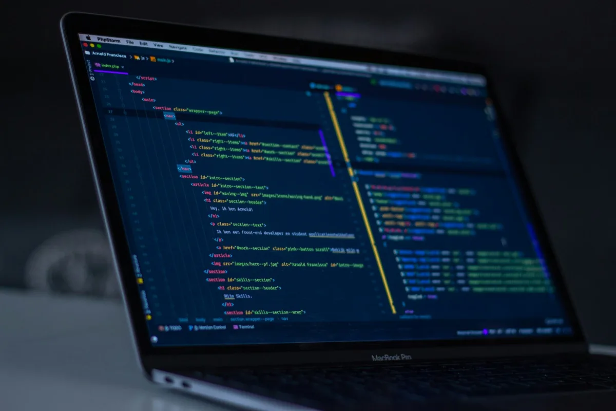 Modern programmer workstation with dark theme IDE displaying clean backend system source code
