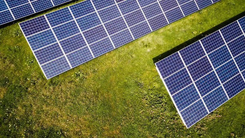 Rooftop solar photovoltaic panels and high efficiency hybrid inverter installation under clear blue sky